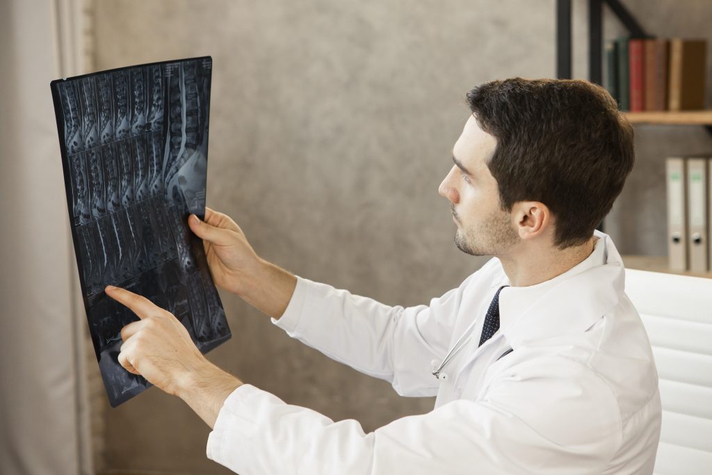 medium-shot-young-doctor-checking-radiography