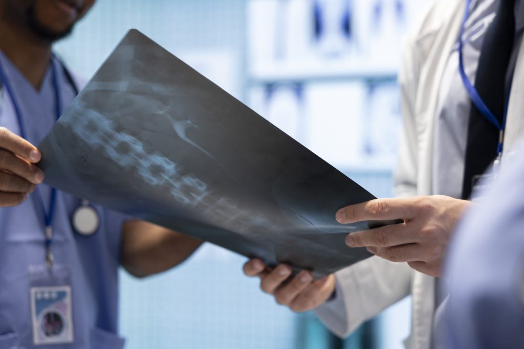 Radiologists team examine x ray scan results in a treatment center facility